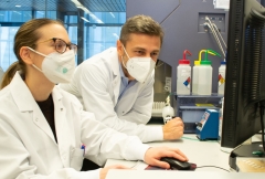 image of two people in front of flow cytometry